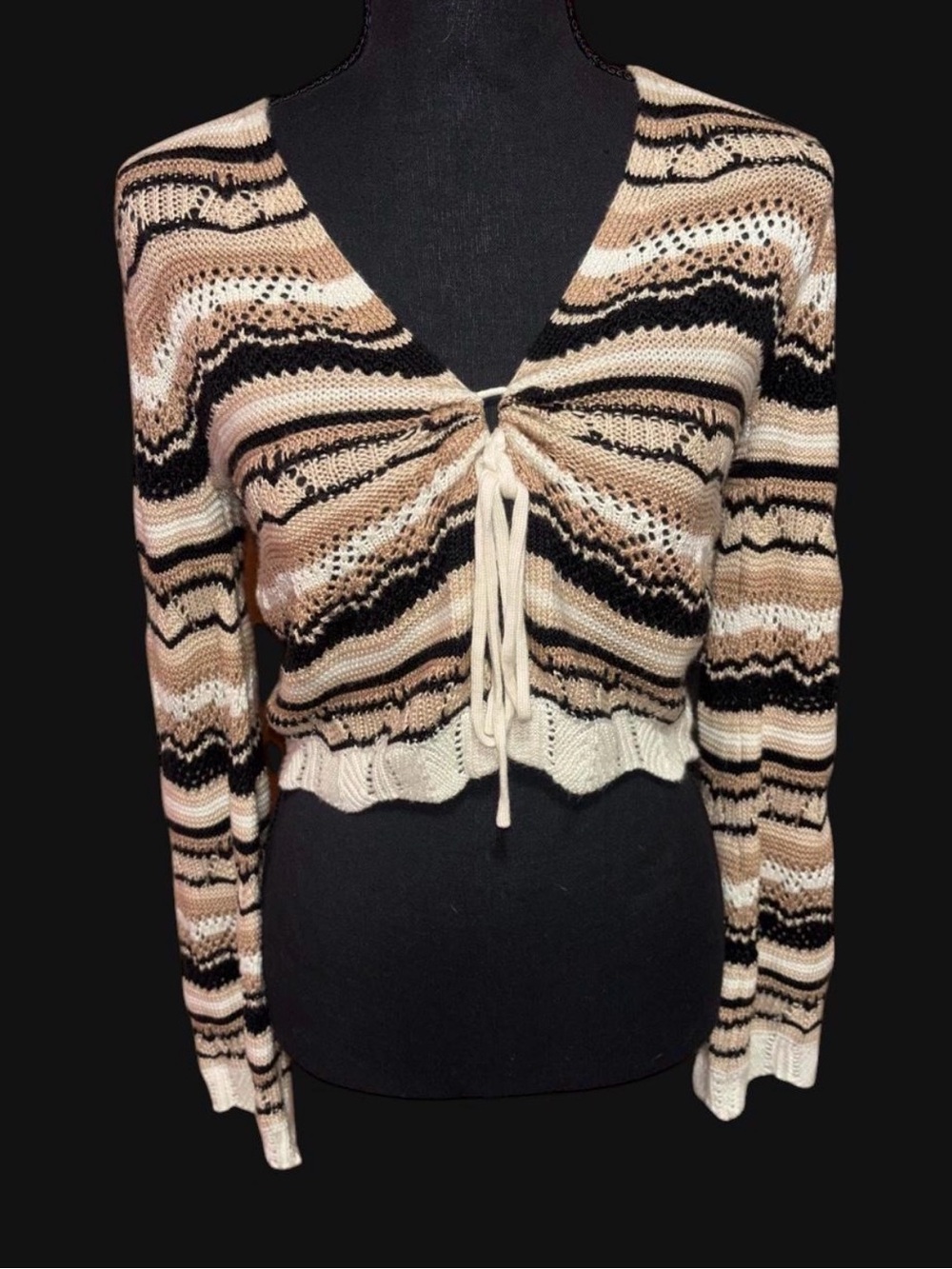 black and beige striped knit sweater with tie front detail.